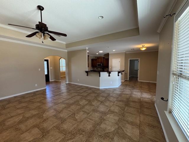 4304 San Pedro Ct, Midland, TX 79707 - unfurnished living room featuring crown molding, ceiling fan, arched walkways, recessed lighting, and baseboards