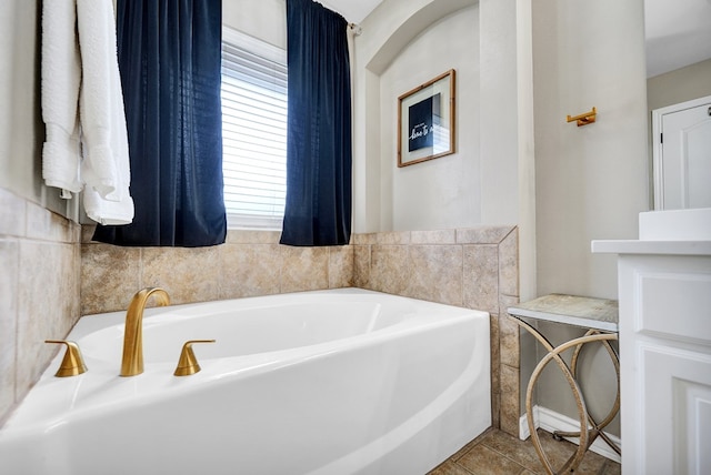 bathroom featuring plenty of natural light, a bath, and tile patterned floors
