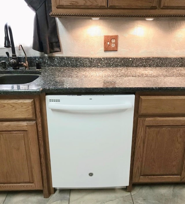 room details with dishwasher, indoor wet bar, and dark stone countertops