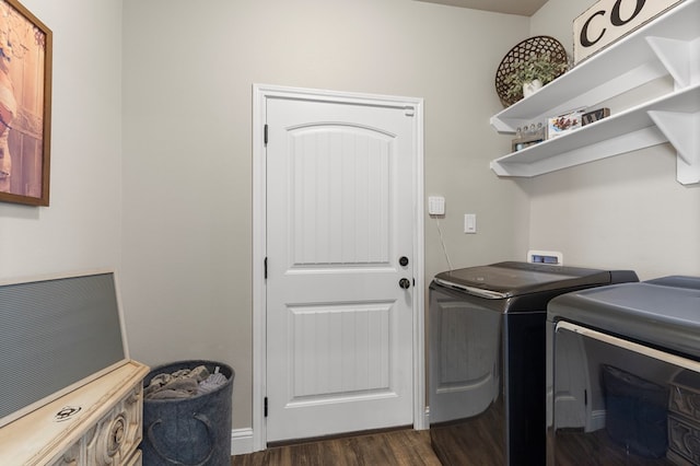 washroom with washer and dryer and dark wood-type flooring