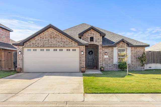 view of front of home with a front lawn and a garage