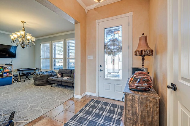 entrance foyer with a chandelier, light tile patterned floors, and crown molding