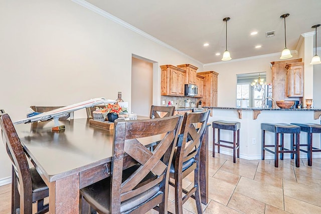 tiled dining space featuring ornamental molding and a notable chandelier