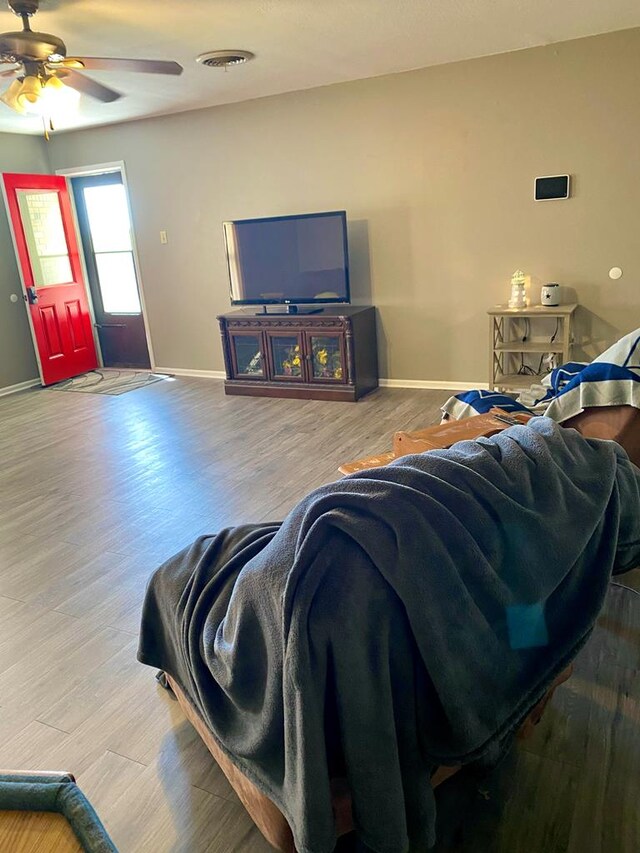 living room with hardwood / wood-style flooring and ceiling fan