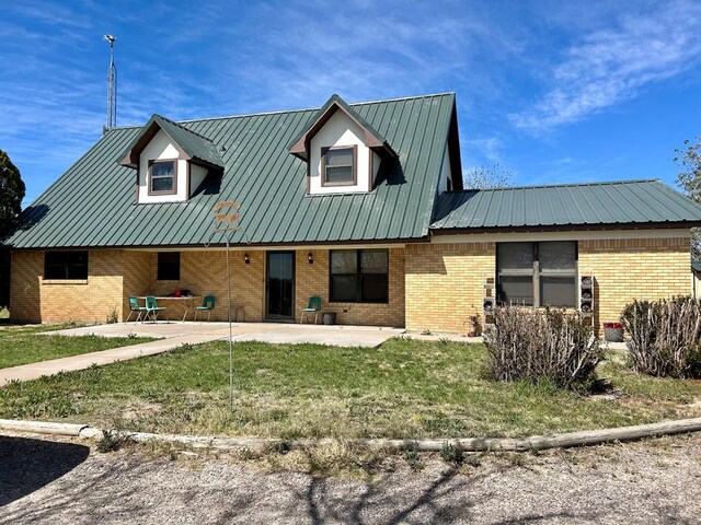 view of front facade with a patio and a front yard