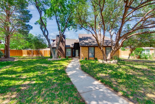 4106 Dyer Cir, Midland, TX 79707 - view of front facade featuring fence, brick siding, and a front yard