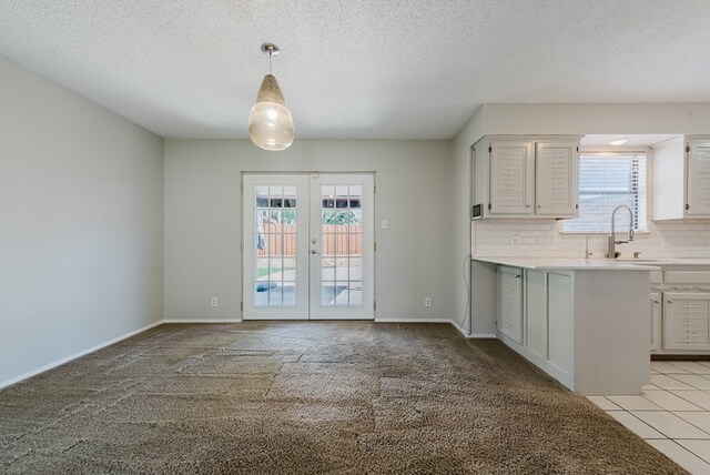 4106 Dyer Cir, Midland, TX 79707 - kitchen featuring light countertops, french doors, a wealth of natural light, and a sink