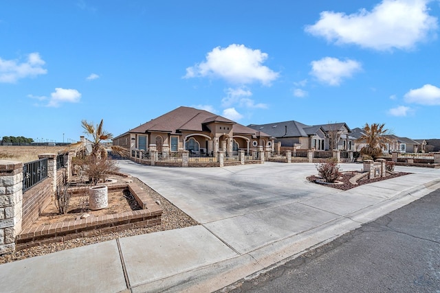 exterior space with a residential view, driveway, and fence