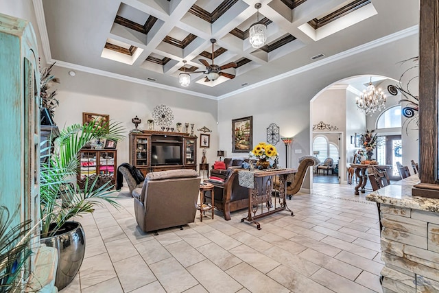 living area with visible vents, arched walkways, a towering ceiling, beam ceiling, and ceiling fan with notable chandelier