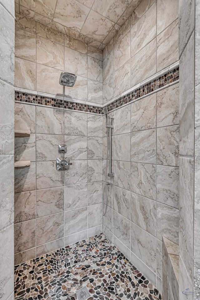 full bath featuring tiled shower