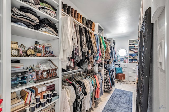 walk in closet with tile patterned floors