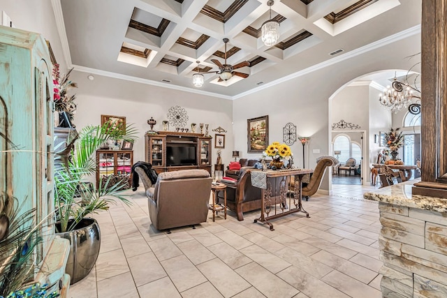 living area with arched walkways, ceiling fan with notable chandelier, a high ceiling, coffered ceiling, and visible vents
