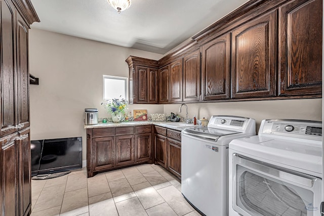 clothes washing area with cabinet space, a sink, and separate washer and dryer