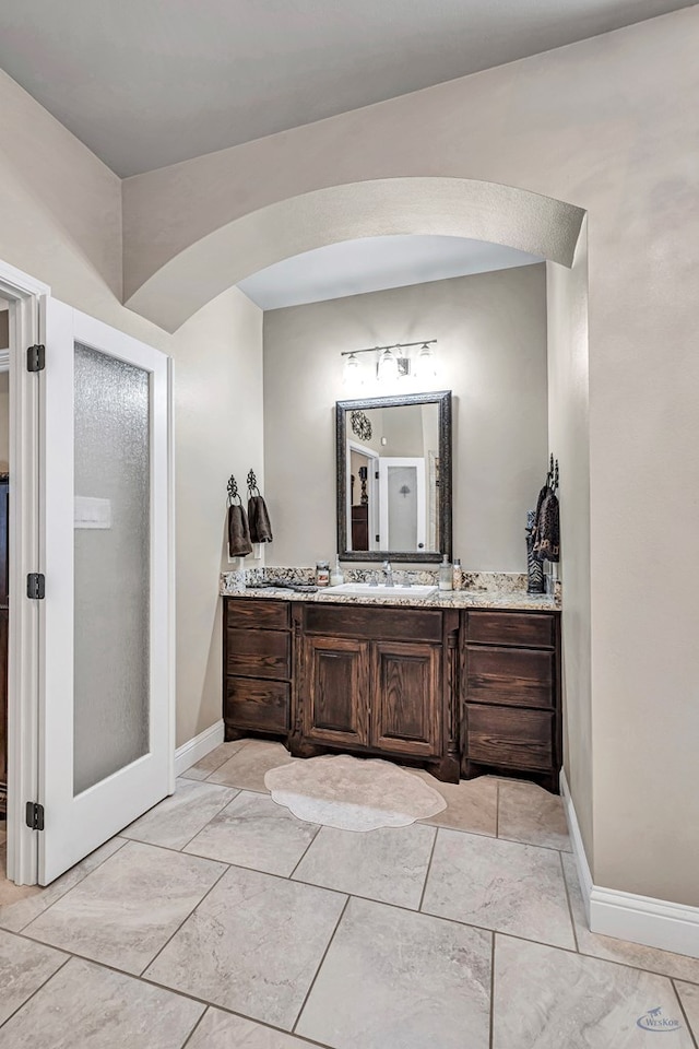 bathroom with vanity and baseboards