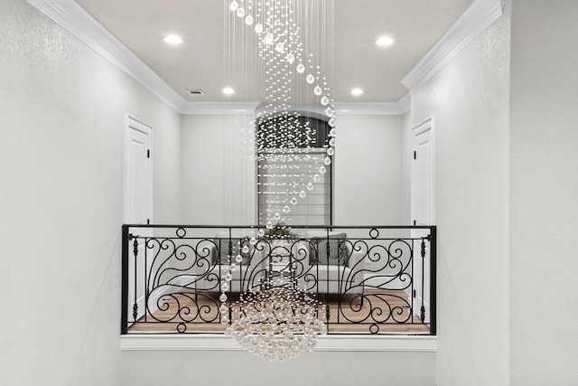 hallway with a notable chandelier and ornamental molding