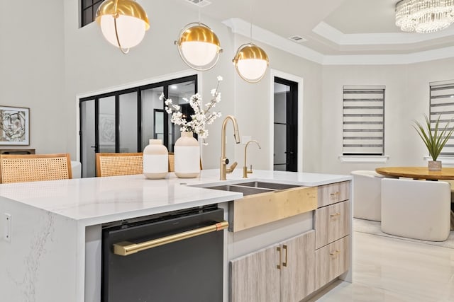 kitchen featuring light stone counters, a kitchen island with sink, light brown cabinets, dishwasher, and hanging light fixtures