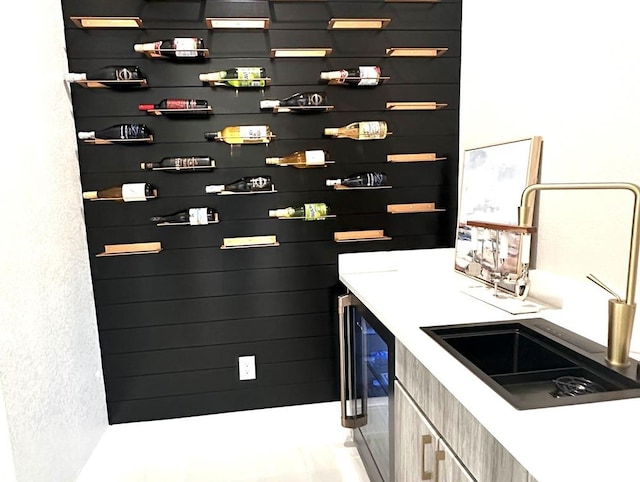 bar featuring sink and beverage cooler