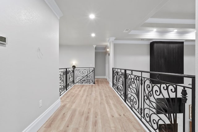 hallway with crown molding and light hardwood / wood-style flooring