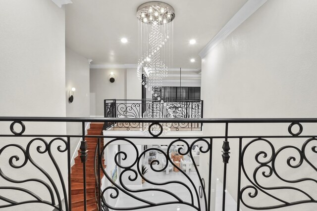 interior space featuring hardwood / wood-style flooring, a notable chandelier, and crown molding