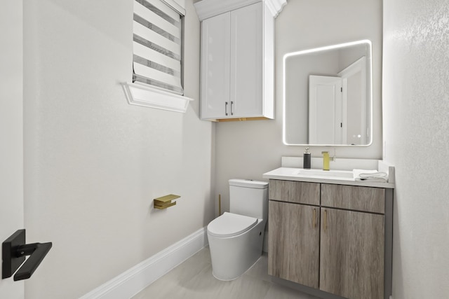 bathroom with tile patterned flooring, vanity, and toilet