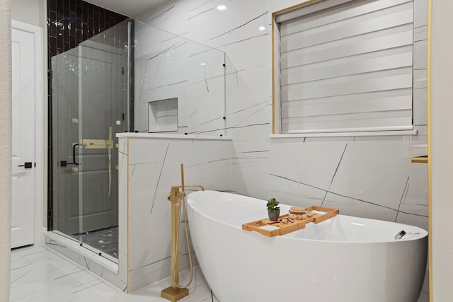 bathroom featuring separate shower and tub