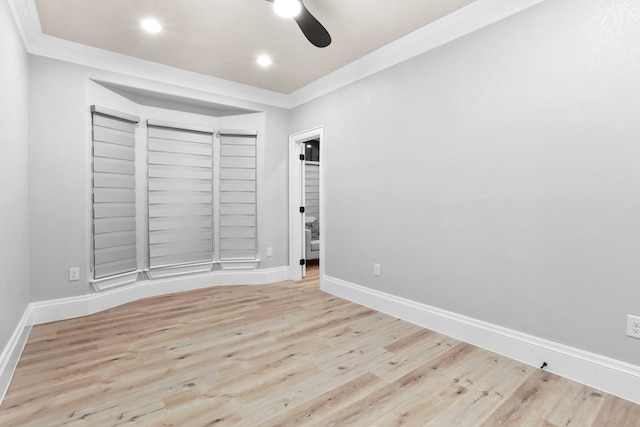 spare room featuring ceiling fan, light wood-type flooring, and crown molding