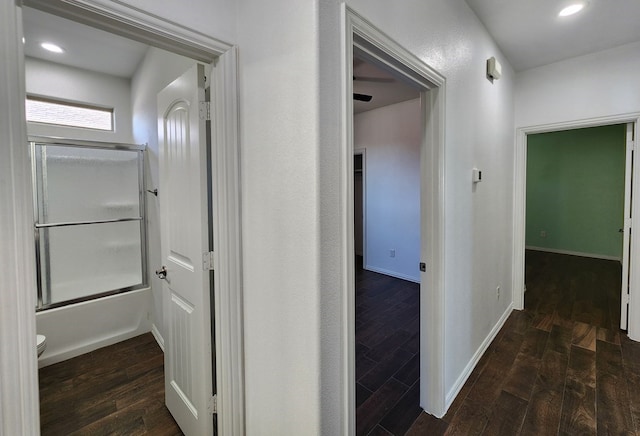 corridor featuring recessed lighting, baseboards, and wood finished floors