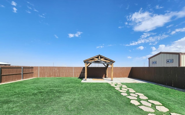 view of yard featuring a gazebo, a patio area, and a fenced backyard