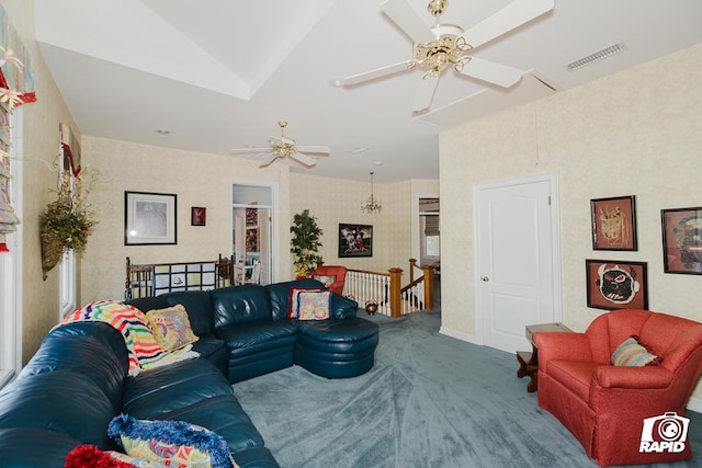 carpeted living room with ceiling fan and vaulted ceiling