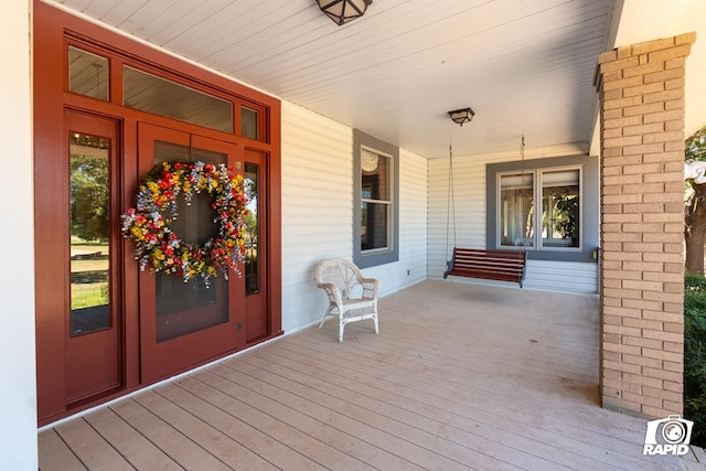 wooden terrace featuring covered porch