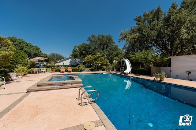 view of pool with a patio area, an in ground hot tub, and a water slide