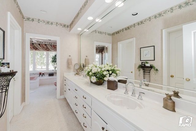 bathroom featuring vanity and a washtub