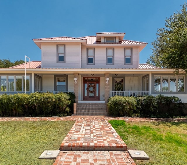 country-style home featuring a front lawn and covered porch