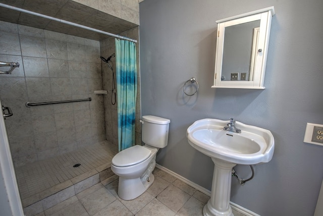 bathroom featuring tile patterned floors, toilet, and curtained shower