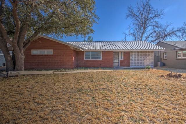 single story home featuring a front yard and cooling unit