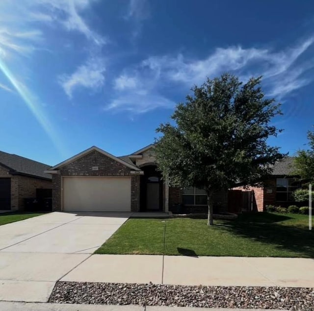 view of front of property featuring an attached garage, driveway, a front lawn, and brick siding