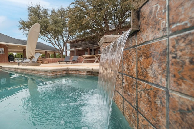 outdoor pool with a patio area