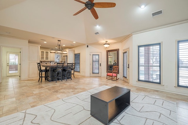 living room featuring high vaulted ceiling, a ceiling fan, visible vents, and crown molding