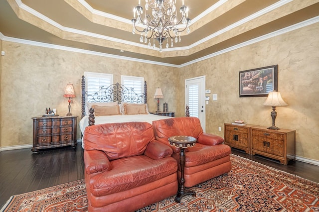 bedroom featuring crown molding, a raised ceiling, hardwood / wood-style flooring, and a notable chandelier