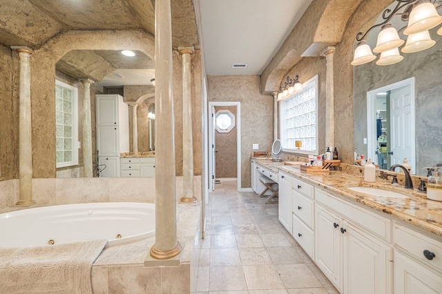 full bathroom with a whirlpool tub, decorative columns, visible vents, and vanity