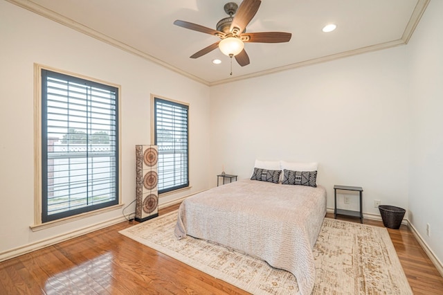 bedroom with baseboards, ornamental molding, wood finished floors, and recessed lighting