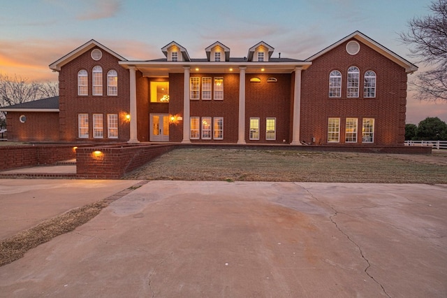 view of front of house featuring brick siding and french doors