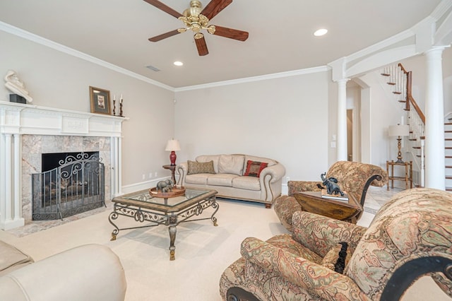 living room with stairs, decorative columns, ornamental molding, and a premium fireplace