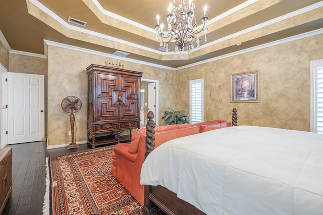 bedroom featuring visible vents, a raised ceiling, wood-type flooring, ornamental molding, and an inviting chandelier