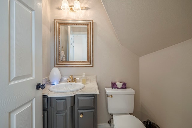 half bathroom featuring toilet and vanity