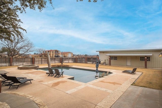 view of swimming pool featuring a fenced backyard, a pool with connected hot tub, and a patio