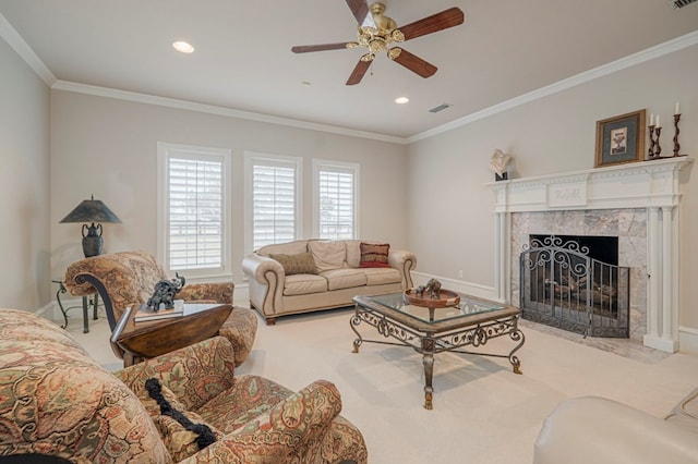 carpeted living room with a ceiling fan, a fireplace, baseboards, and crown molding