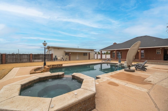 view of swimming pool with a patio area, fence, an outbuilding, and an exterior structure