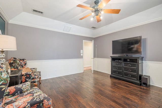 sitting room featuring a raised ceiling, wainscoting, ceiling fan, and hardwood / wood-style flooring