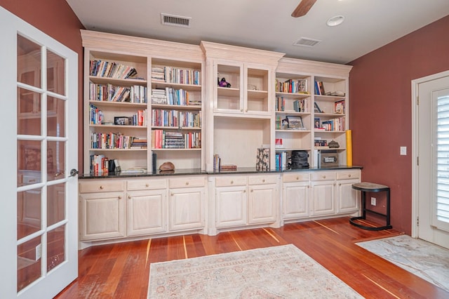 unfurnished room featuring visible vents, ceiling fan, and wood finished floors